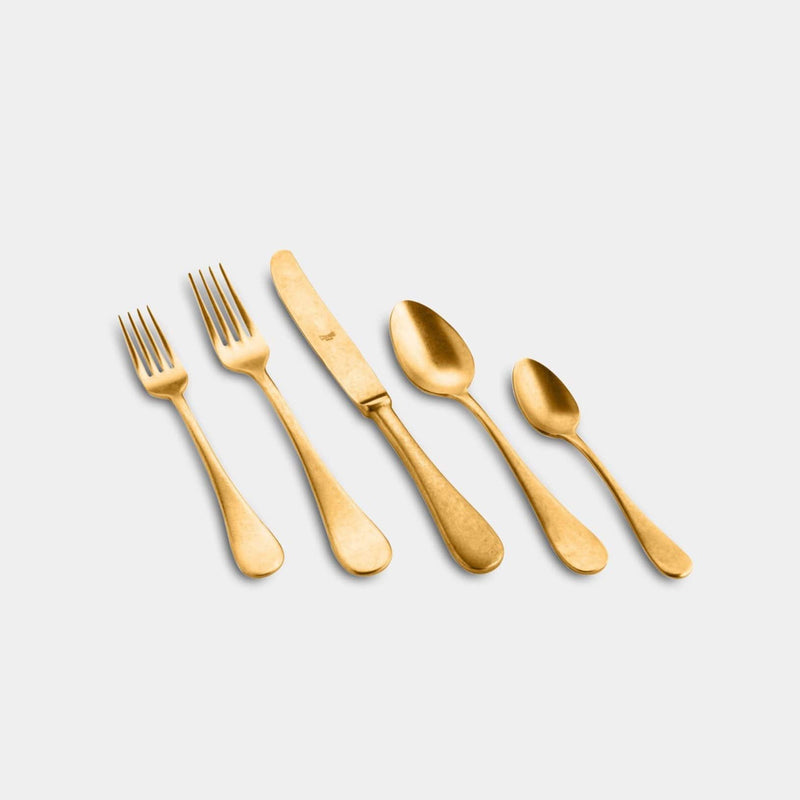 Made in Italy the matte gold five piece flatware set makes for a timeless plate setting: fork, knife, spoon, salad fork, and dessert spoon.